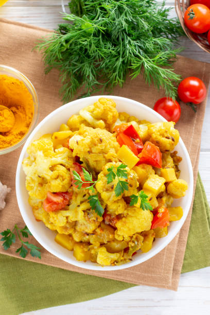 istock Indian food table - vegetarian cauliflower curry. Top view 1320497979