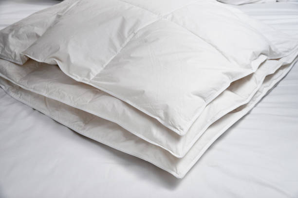 White blanket (quilt) on the bed White blanket (quilt) on the bed duvet stock pictures, royalty-free photos & images