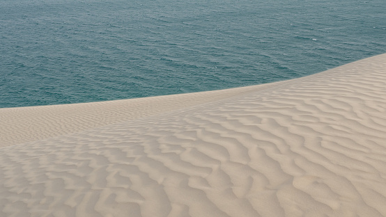 sand ripple effect in the desert sand dunes in Qatar. selective focus
