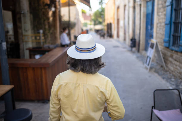 istock Mature man with hat exploring city alone during his spring vacation 1320501595