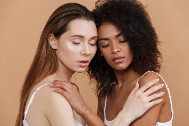 istock Two pretty women posing together and hugging to each other 1320503006