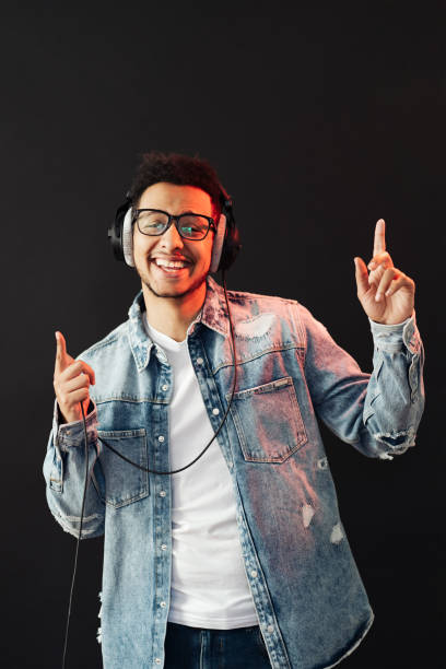 istock Carefree dark skinned guy listens lively music 1320504005