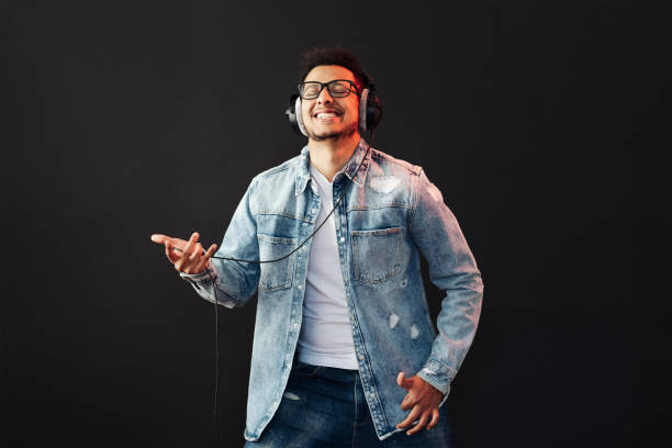 istock Carefree dark skinned guy listens lively music 1320504010