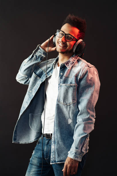 istock Carefree dark skinned guy listens lively music 1320504064