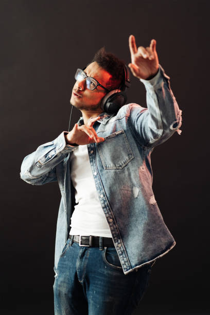 istock Carefree dark skinned guy listens lively music 1320504084
