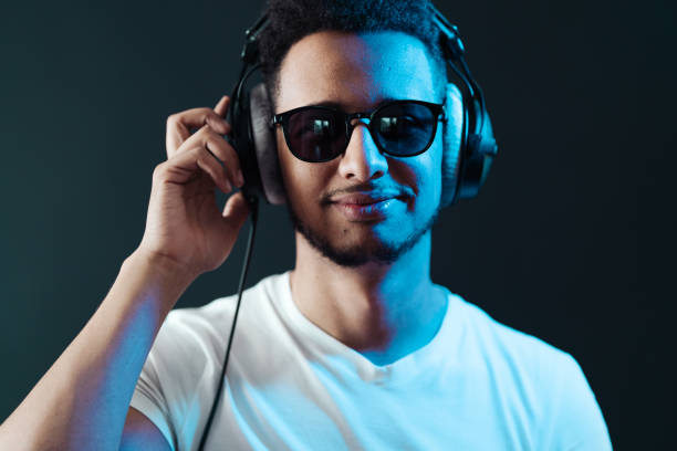 istock Carefree dark skinned guy listens lively music 1320504127