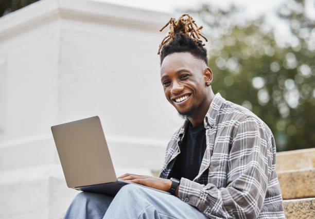 istock Shot of a young man using a laptop on campus 1320507980