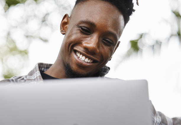istock Shot of a young man using a laptop on campus 1320508276