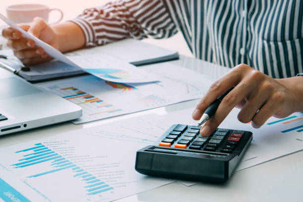 istock accountant use calculator and computer for financial check. finance and accounting concept 1320509085