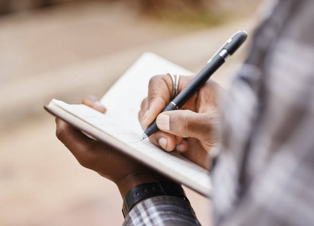 istock Cropped shot of a man writing in a notebook on campus 1320509444