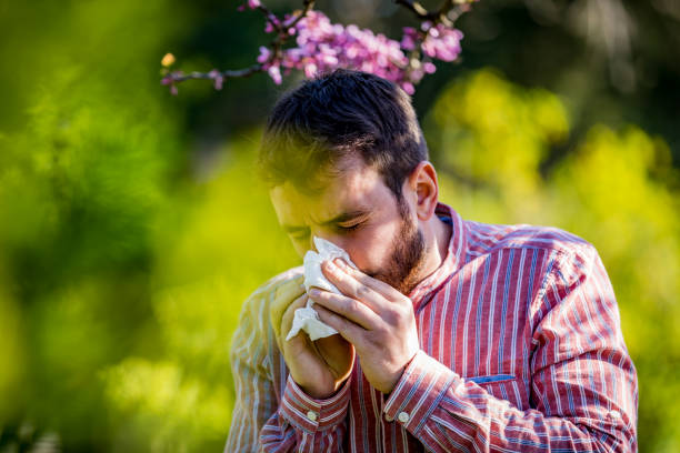 istock Man with allergy or an infection sneezing 1320509831