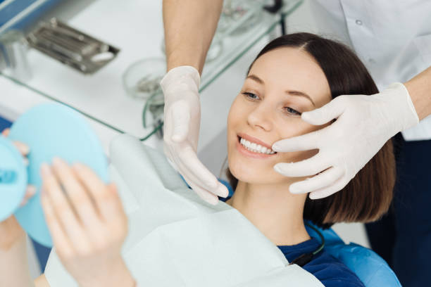 Dentist hands and happy patient looking in mirror after treatment stock photo