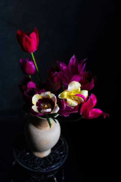 istock Assorted tulips in bowl on dark background 1320512131