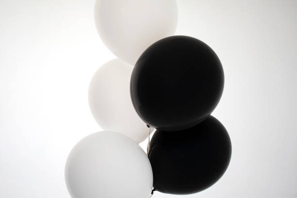 Black and white helium party balloons isolated on white background with copyspace