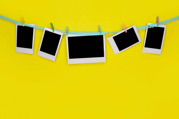 istock Blank photo frames hanging on clothesline. 1320513156