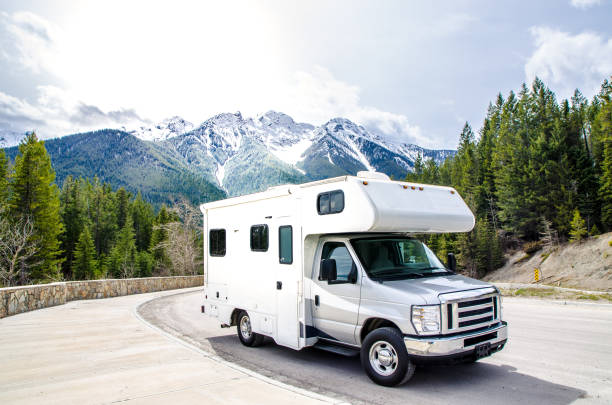 Motorized home parked in rest area Motorized home parked in rest area in British Columbia with Rocky mountains behind motor home photos stock pictures, royalty-free photos & images
