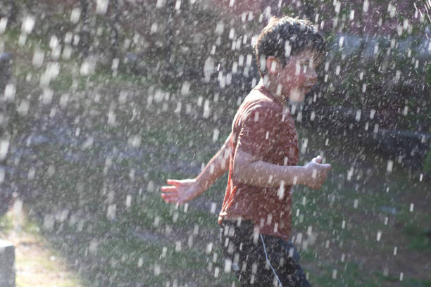 istock Happy child in the summer rain. 1320518187