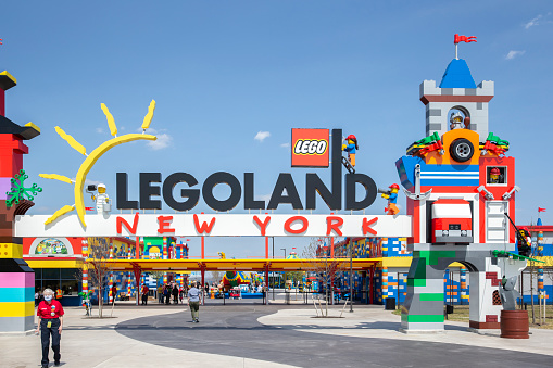 Brooklyn, NY - April 24 2021:  Visitors pass through the colorful entrance gate to Legoland in New York. Lego building blocks