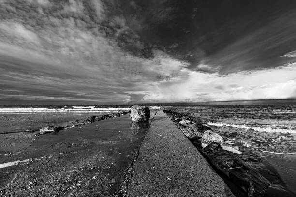 istock Clouds over Villers-sur-mer waterfront - Normandy, France 1320521994