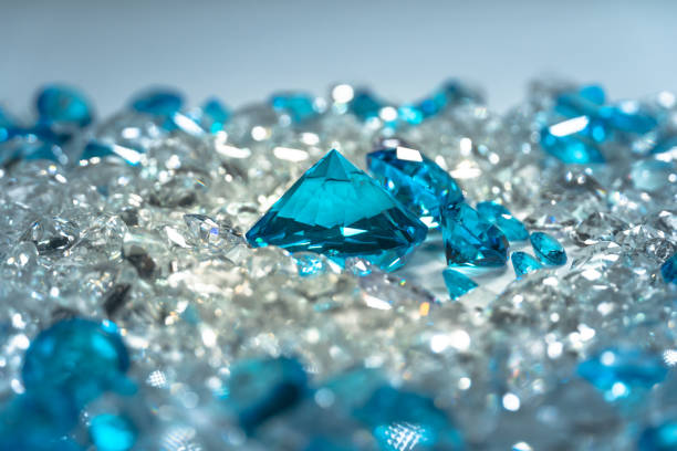 A group of aquamarine blue diamonds arranged in the middle of white diamonds on a white background.\