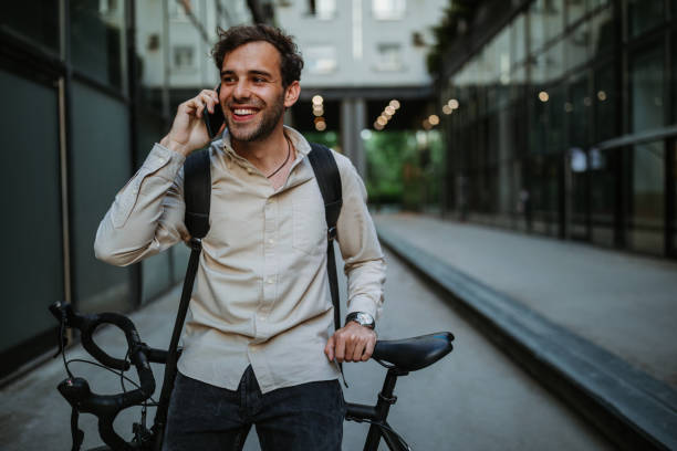 istock Young businessman with bike using mobile phone 1320525225