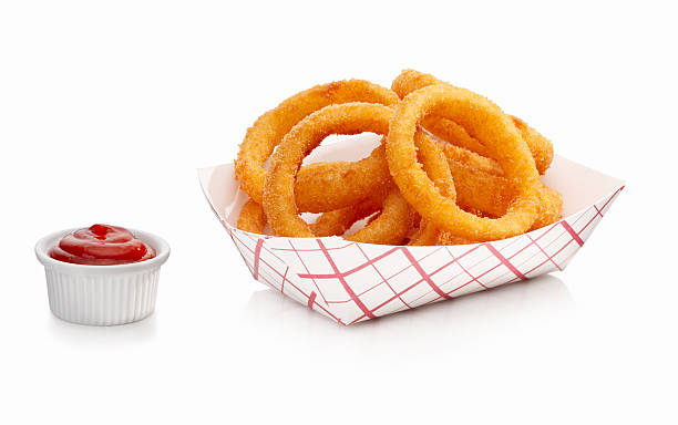 Onion Rings and Ketchup Fresh Onion Rings with a side of ketchup on a white background fried onion rings stock pictures, royalty-free photos & images