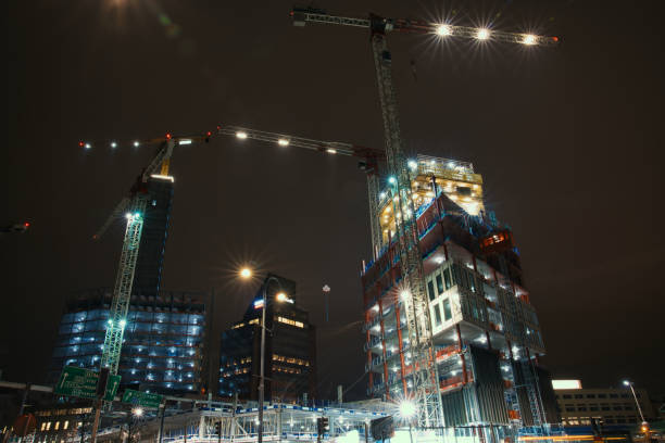 istock Big cranes and buildings under construction, night 1320527367