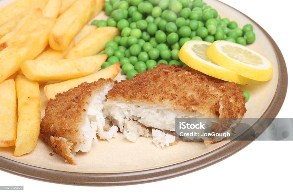 Haddock, Chips and Peas Breaded haddock fillet with chips and peas. Breadcrumbs Stock Photo