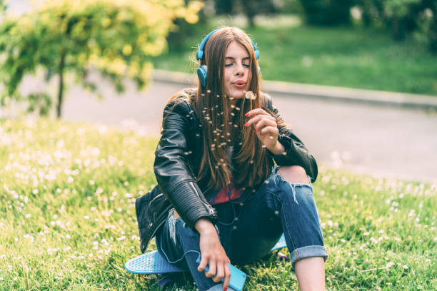 istock Young woman blowing dandelion 1320529943