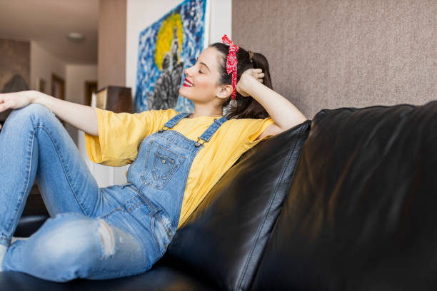 istock Relaxed serene young woman lounge on comfortable sofa at cozy home 1320530291