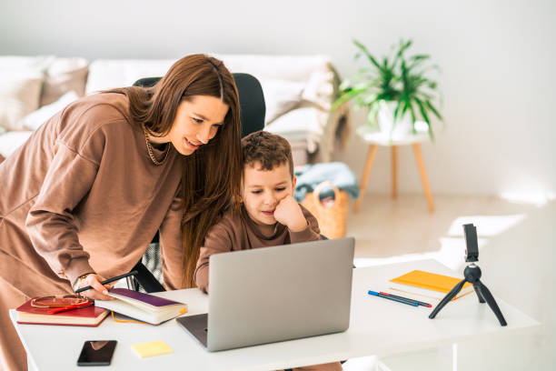 istock Mom and son doing school homework on laptop 1320532635