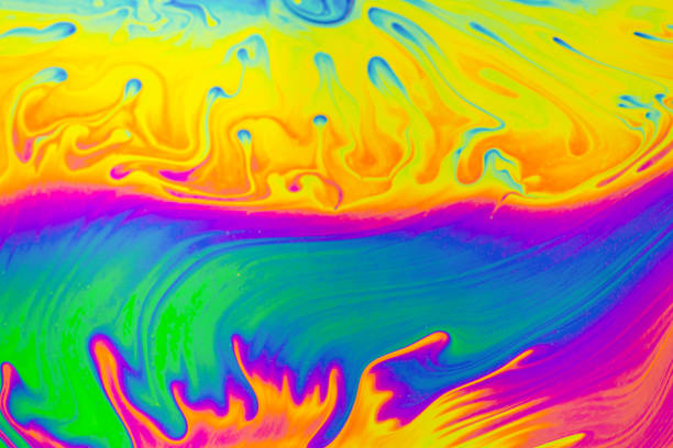 istock Rainbow colors. Psychedelic multi colored patterns background. Photo macro shot of soap bubbles 1320533213