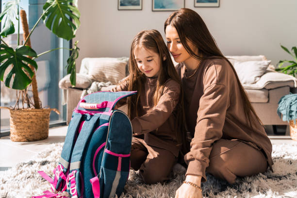 istock Mom and daughter are preparing schoolbag 1320533411