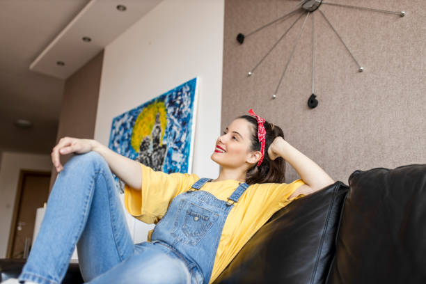 istock Relaxed serene young woman lounge on comfortable sofa at cozy home 1320534469