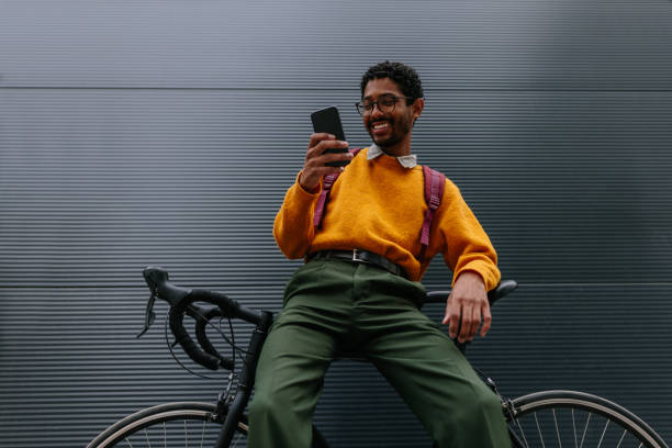 istock Hipster cyclist in the city using phone 1320536405