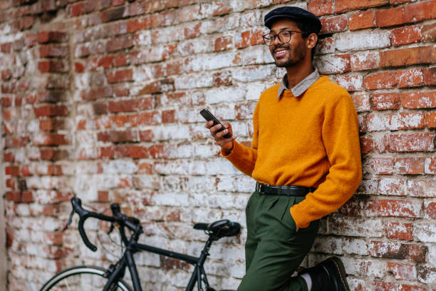 istock Male stylish cyclist using phone 1320536443