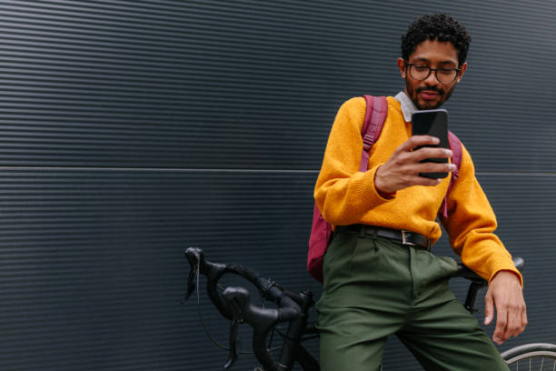istock Young man hanging out in the city and using cellphone 1320536462