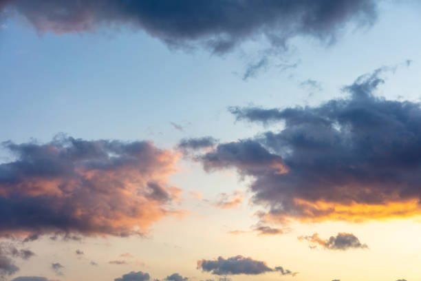 istock Sunset, sunrise, sunbeams through dark clouds on blue sky background. 1320536492