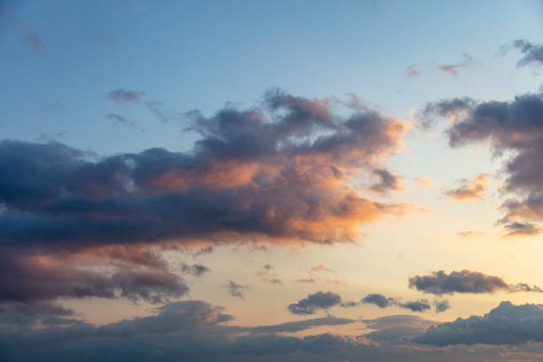 istock Sunbeams through heavy dark clouds on blue sky background. 1320536493