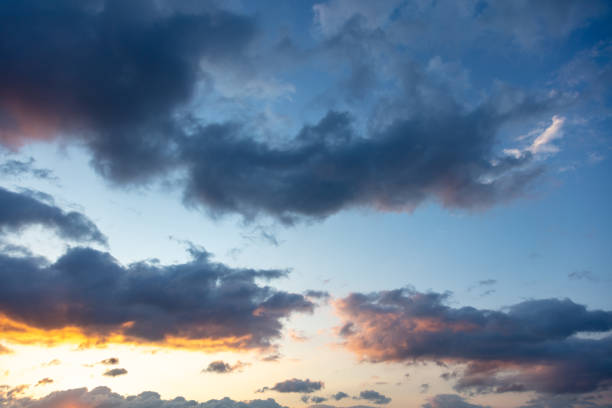 istock Sunbeams through dark clouds on blue sky as background. 1320536494