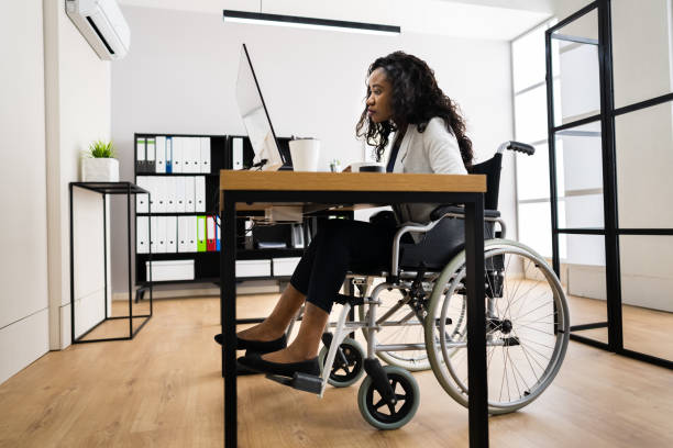 istock Disabled African Worker In Wheelchair Working 1320536547