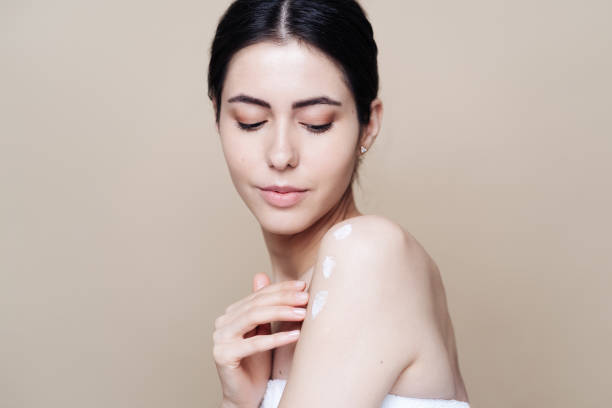 istock Beautiful Caucasian woman applying cream on face 1320537471