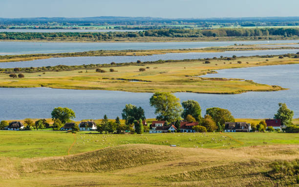 View of the village of Grieben and the peninsula Bessin with the bird sanctuary on the Baltic Sea island of Hiddensee, in the background Rügen.