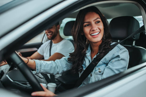 Young couple traveling by car Happy couple enjoying while traveling by car and going on trip driving stock pictures, royalty-free photos & images