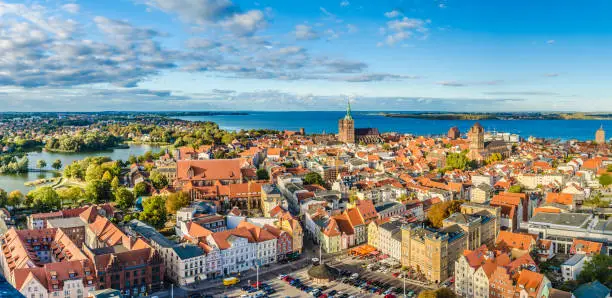 Panoramic view from the top of the old town of Stralsund in summer, in the background the Baltic Sea with the island of Rügen.