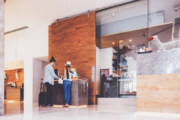 istock Couple at a luxury hotel reception checking-in 1320539981