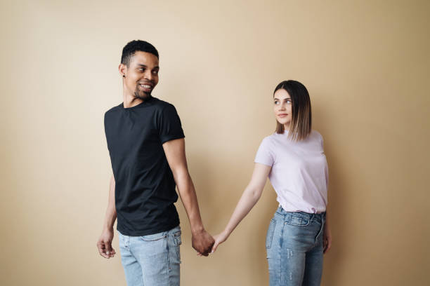 istock Young diverse couple holding hands, agree to bring the plan to life 1320542457