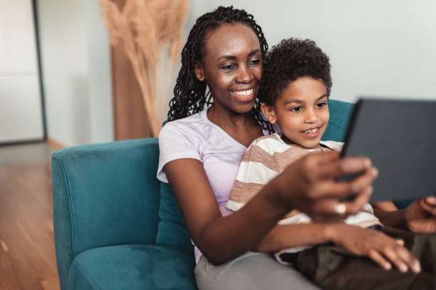 istock The son and mother are lying on the sofa and talking via a digital tablet 1320543786