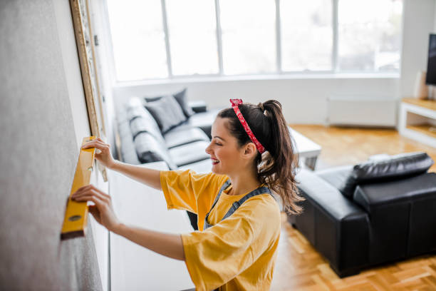 istock Woman is assembling furniture at home 1320543817