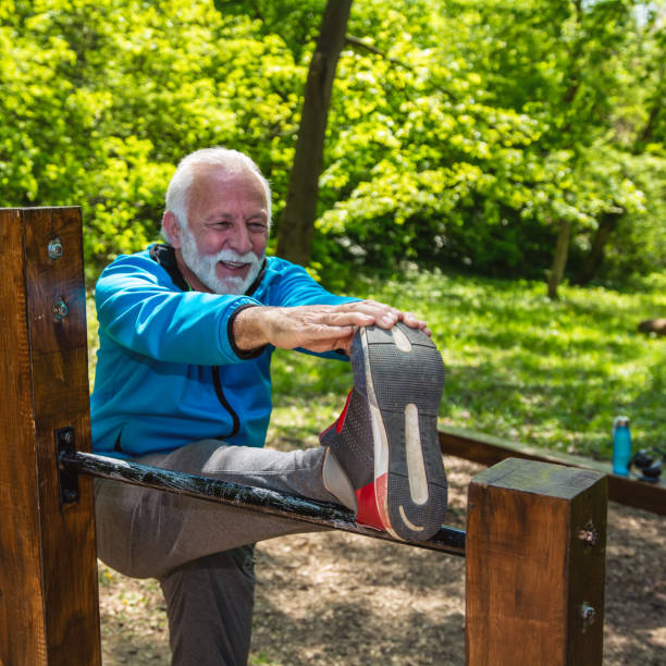 istock Senior man stretching after jogging in a public park. 1320544462